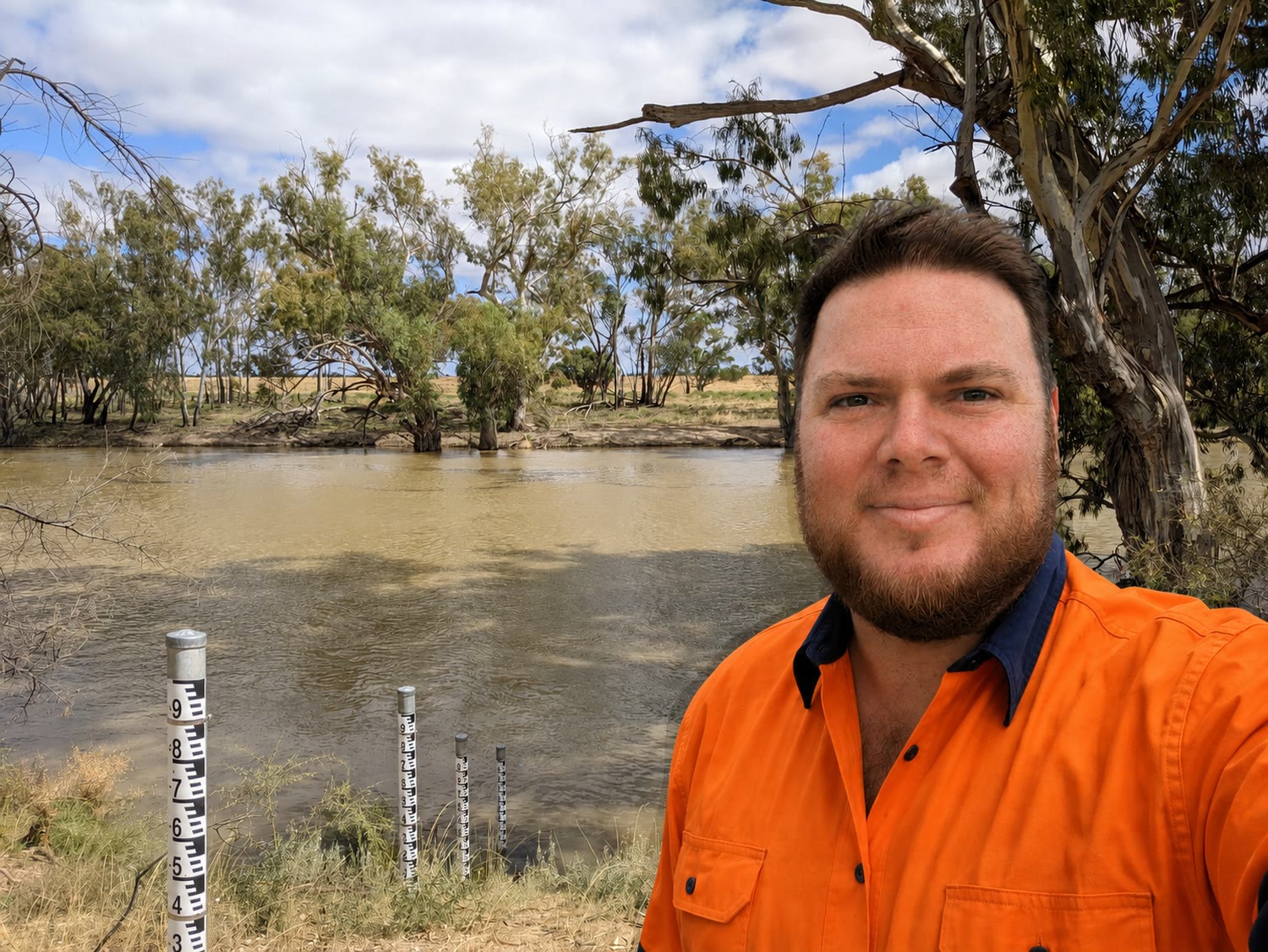 Robbie Heane on the riverbank beside a run of staff gauges